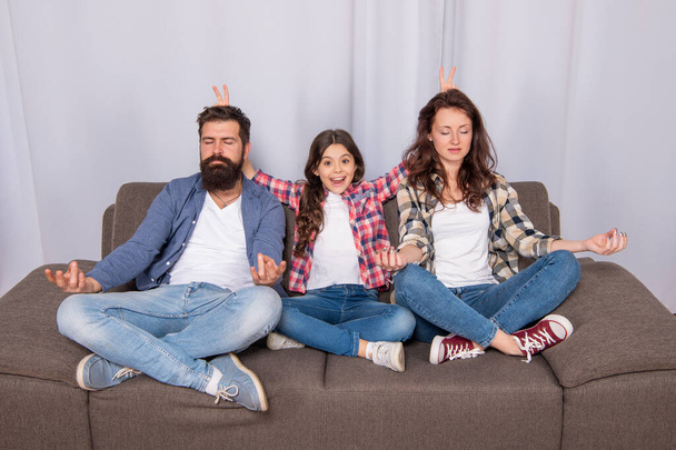 father mother and child on sofa. friendly family having fun. happy parents with kid girl - Фото, зображення