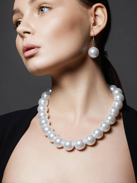 Beautiful young woman with pearl jewelry. pearl beads on girl - Photo, Image