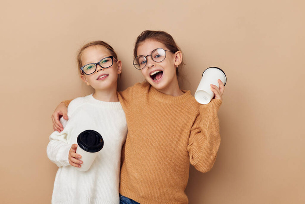 two little girls with disposable glasses in their hands - Foto, immagini