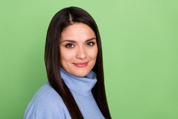 Photo of cute millennial brunette lady wear blue sweater isolated on green color background - Foto, Imagem