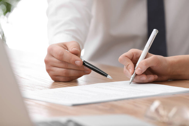 Businesspeople signing contract at table in office, closeup - Foto, Imagen