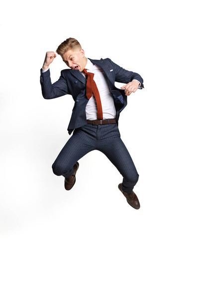 Excited young businessman, student, diplomat jumping isolated on white studio background. Human emotions, facial expression concept. - Photo, Image