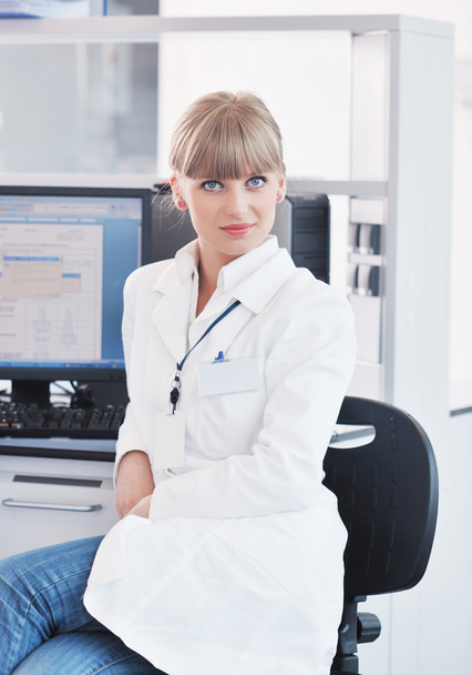 Female researcher holding up a test tube in lab - Фото, зображення