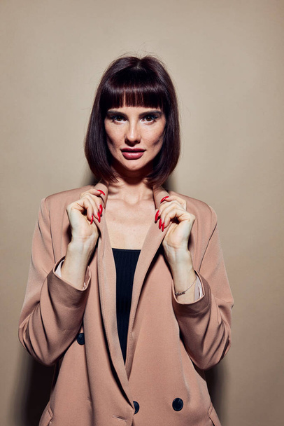 photo pretty woman short haired suit gesturing with hands isolated background - Valokuva, kuva