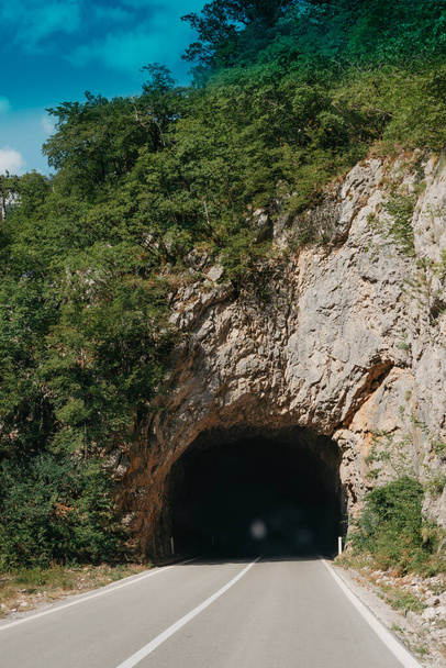 Empty route and small tunnel in mountain - 写真・画像