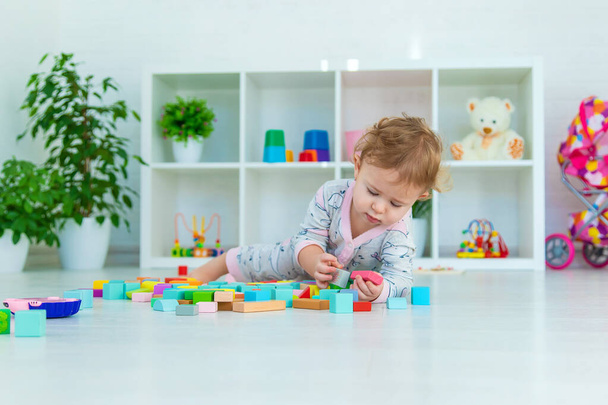 Een baby speelt met speelgoed in de speelkamer. Selectieve focus. Jongen. - Foto, afbeelding