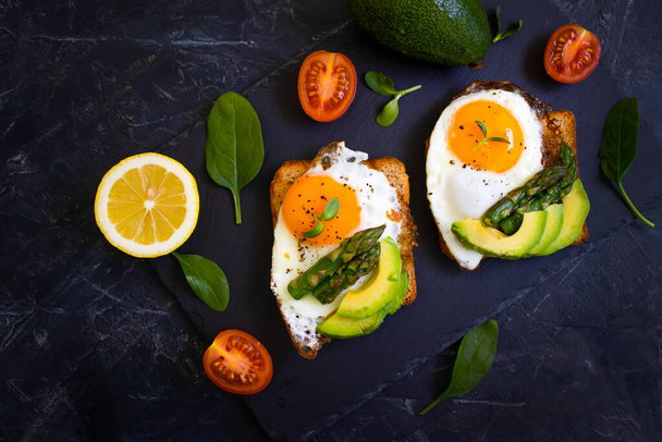 sandwich with egg, avocado, asparagus on old background - Фото, изображение