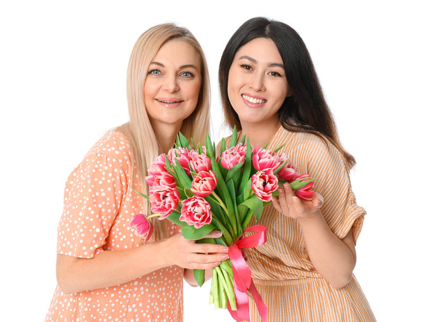 Beautiful women with bouquet of flowers on white background. International Women's Day celebration - Photo, Image