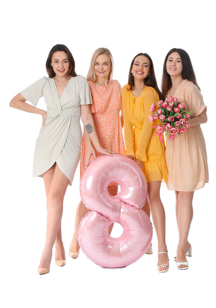 Beautiful women with bouquet of flowers and balloon on white background. International Women's Day celebration - Photo, Image