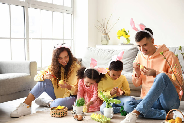 Little children with their parents painting Easter eggs at home - Photo, Image