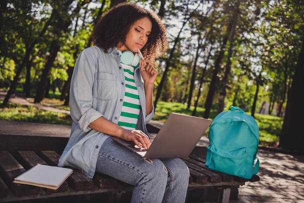 Profile side photo of young african woman concentrated thoughtful minded look laptop search materials outdoors - Φωτογραφία, εικόνα