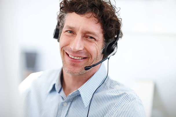 What can I do for you today. Cropped portrait of a handsome call center operator in the office. - Photo, Image