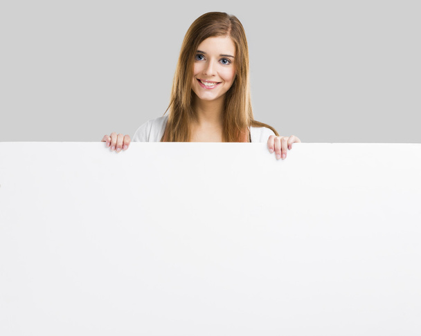 Woman with a big blank board - Photo, image