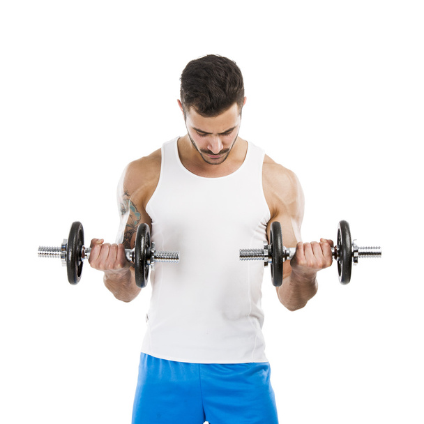 Athletic man lifting weights - Foto, afbeelding