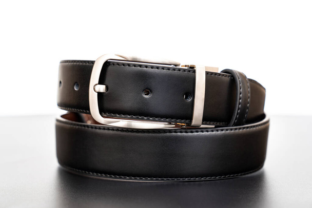  black leather belt on a black table.  - Photo, Image