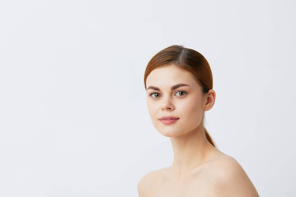 portrait woman red hair bare shoulders cosmetics skincare light background - Foto, Imagem