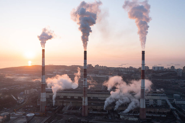 A working factory with chimneys billowing with smoke - Photo, Image