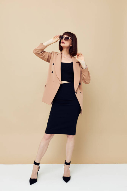 attractive woman in sunglasses short haired suit gesturing with hands isolated background - Fotoğraf, Görsel