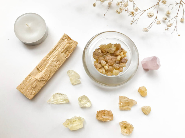 Set of palo santo sticks, rose quartz crystal and natural incense and dammar resins, close-up on a white background, place for text, altar layout - Fotografie, Obrázek
