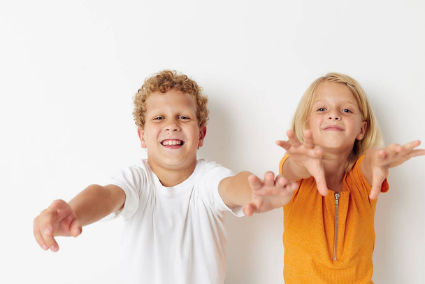 Cute preschool kids posing hand gesture smile casual wear isolated background unaltered - Foto, afbeelding