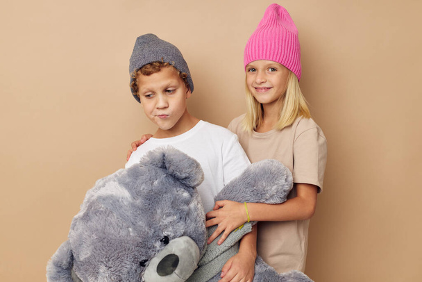 Cute stylish children in hats with a teddy bear friendship Lifestyle unaltered - Foto, imagen
