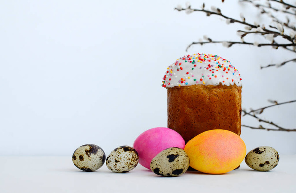 Easter cake, painted eggs, willow branches on white background with copy space. - Фото, изображение