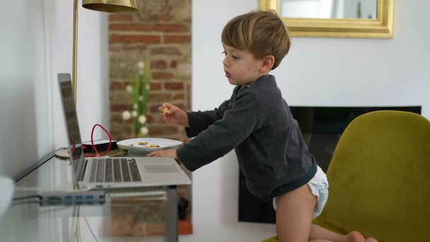 Baby boy wearing diapers in front of laptop at home 2 year old toddler - Φωτογραφία, εικόνα