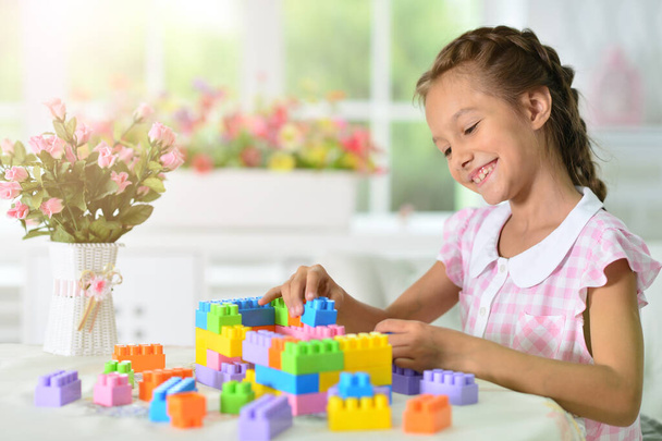 Happy cute little girl playing with cubes - Photo, Image