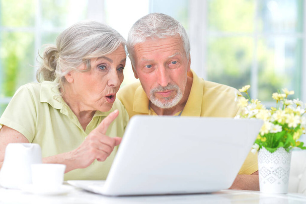 confused  senior couple with laptop at home - Photo, Image
