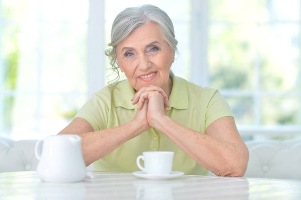 Portrait of beautiful senior woman with cup of  tea at home - Foto, Bild