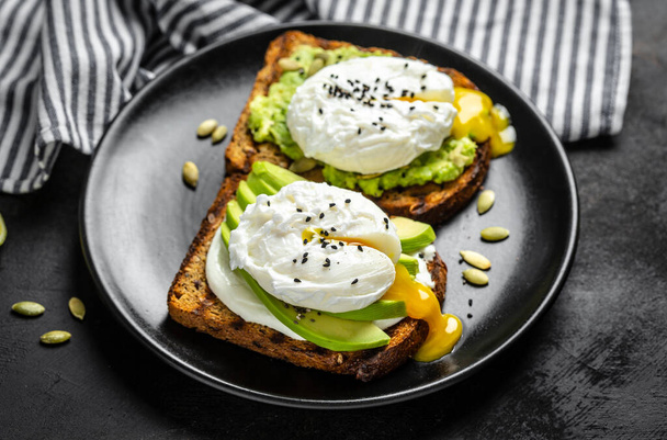 Sandwiches with avocado and poached egg. Healthy food, keto diet, diet lunch concept. Top view. - Photo, Image