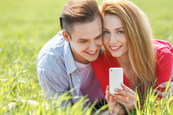 Couples with mobile phone - Foto, afbeelding