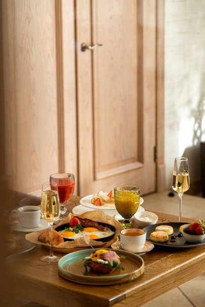 breakfast table with a variety of dishes and drinks - Photo, image