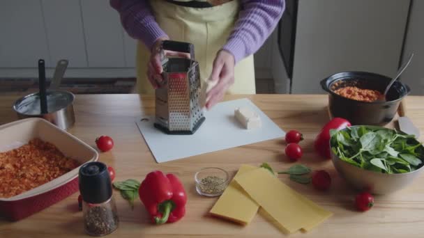 Woman In Yellow Apron Is Rubbing Cheese - Footage, Video