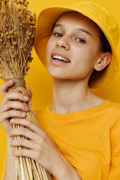 young woman a bouquet of dried flowers in hands Youth style casual wear in Hat - Fotó, kép