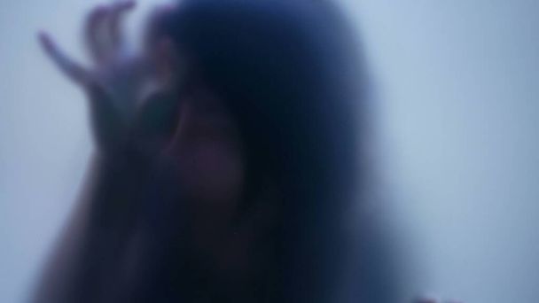Defocused shot of person trapped in emotional problems behind glass depression concept - Фото, зображення