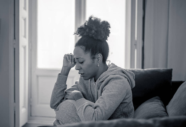 Unhappy lonely young african american woman suffering from anxiety, stress and depression feeling alone and distressed at home. Mental health and social isolation among young people concept. - Fotó, kép