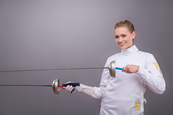 Young woman engaging in fencing - 写真・画像