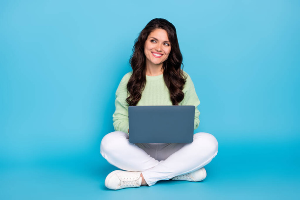 Portrait of attractive curious minded cheerful woman sitting using laptop thinking copy space isolated over bright blue color background. - Foto, Bild