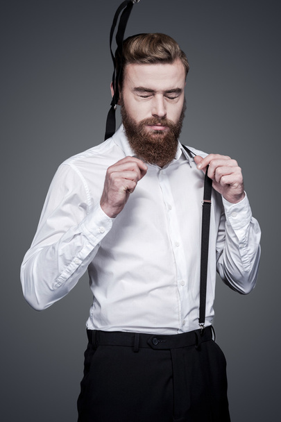 Bearded man adjusting his suspenders - Foto, imagen
