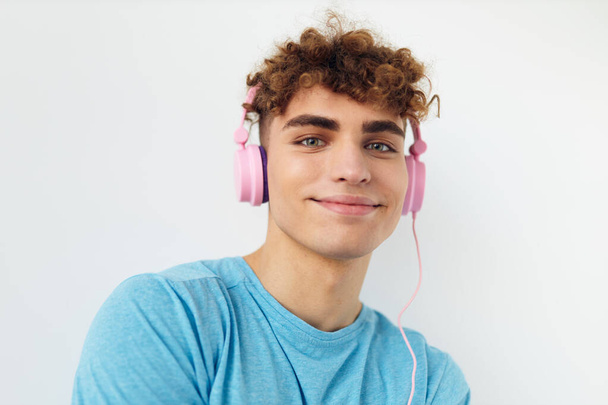 Attractive man in blue t-shirts pink headphones fashion Lifestyle unaltered. High quality photo - Φωτογραφία, εικόνα