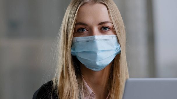 Portrait caucasian 30s business woman marketing specialist bank worker insurance agent female with laptop masked manager blonde wears facial protective mask in office looking at camera work pandemic - Fotografie, Obrázek