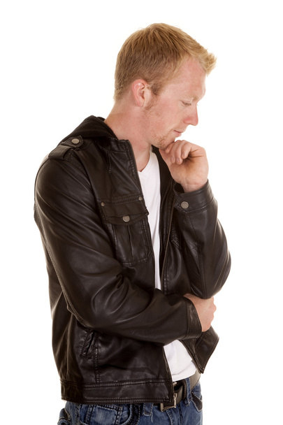 A man in a black jacket and white shirt look down - Photo, image
