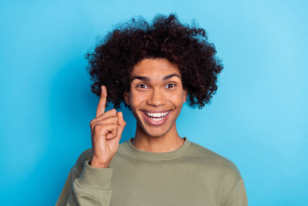 Photo of young cheerful guy point finger inspiration choice smart creative isolated over blue color background. - Foto, afbeelding