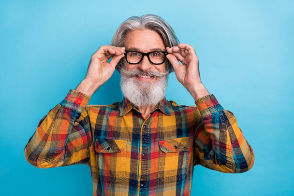 Photo of cheerful aged man hands touch eyeglasses smart confident visit ophthalmologist isolated over blue color background. - Photo, image