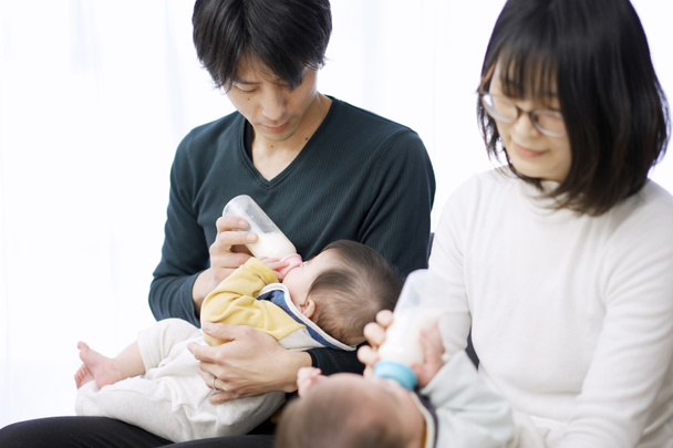 Asian parents feeding twin babies milk - Photo, Image
