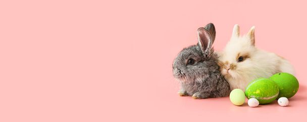 Cute rabbits and Easter eggs on pink background with space for text - Photo, Image