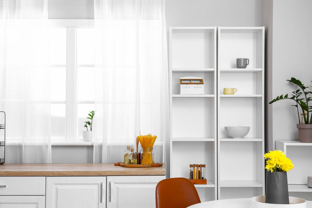 Interior of light kitchen with white shelving unit - Photo, Image