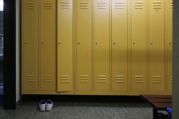 yellow lockers and a pair of shoes stand in a locker room in a hospital - Fotografie, Obrázek