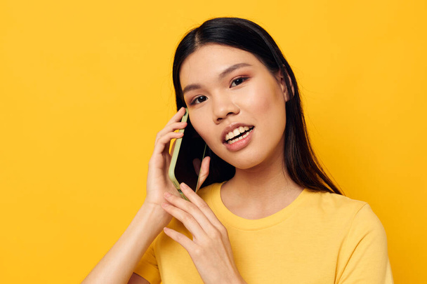 woman with Asian appearance communicates on the phone emotions Lifestyle unaltered - Fotó, kép